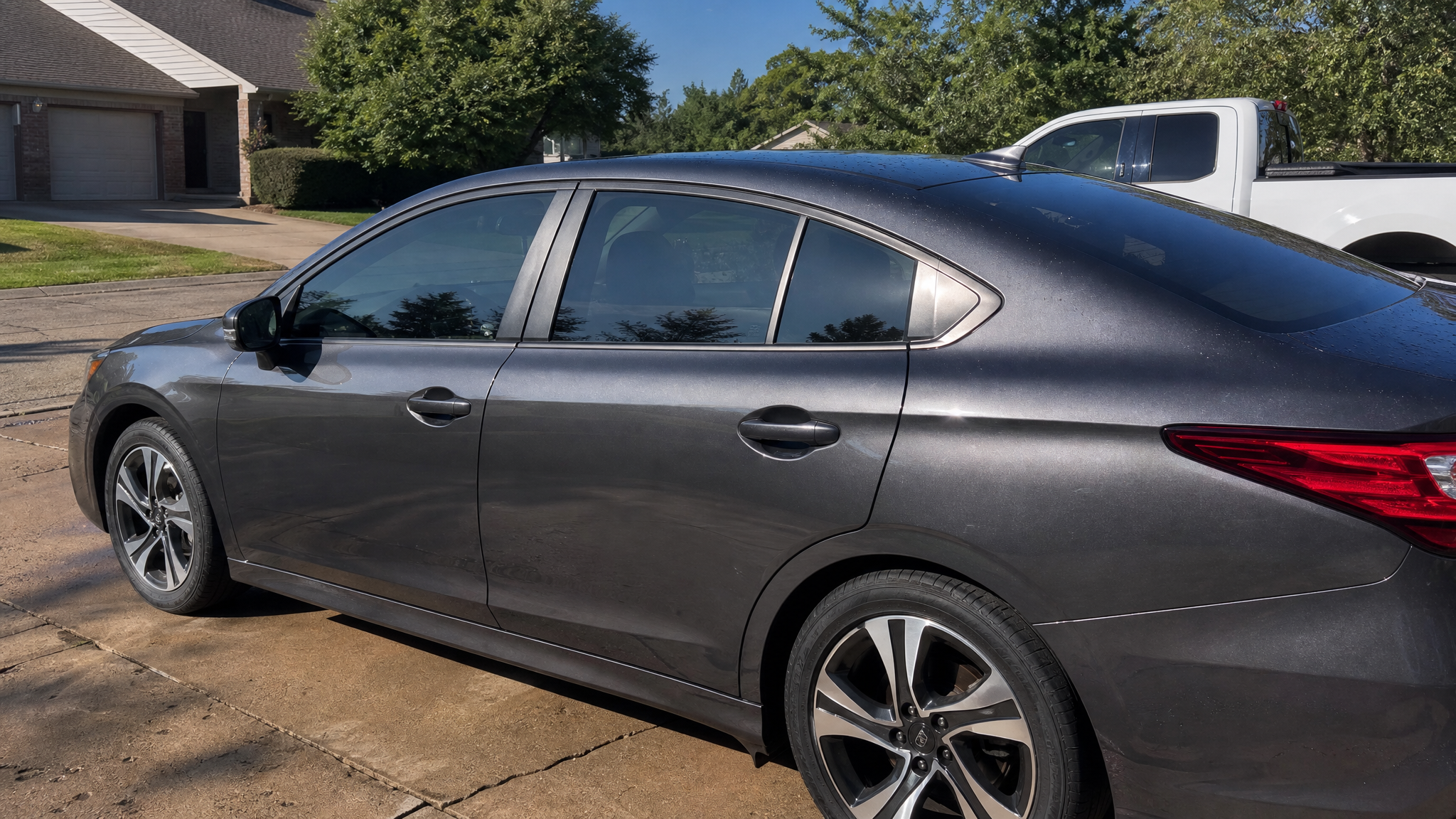 Daily-driver sedan with realistic 35 percent window tint in afternoon sunlight
