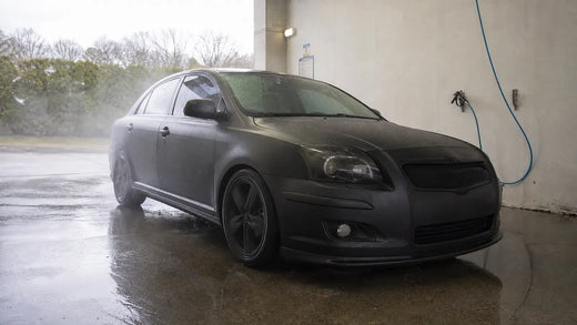 Wrapped car in a self serve wash bay for safe vinyl wrap cleaning
