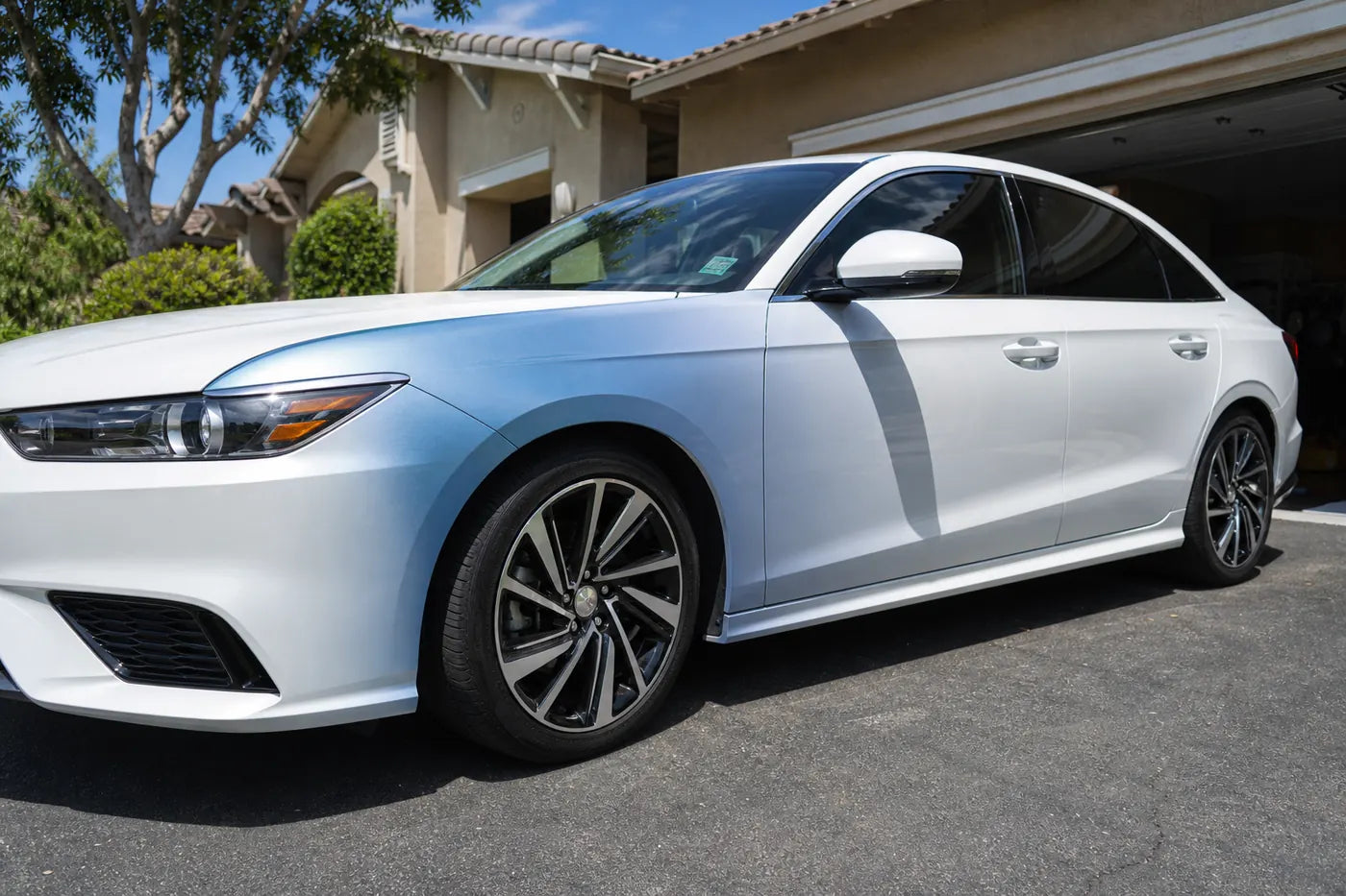 White car with vinyl wrap color shift in natural daylight