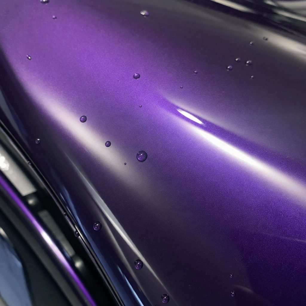 Close-up of Bright Black Purple gloss colored PPF surface texture | Veloro