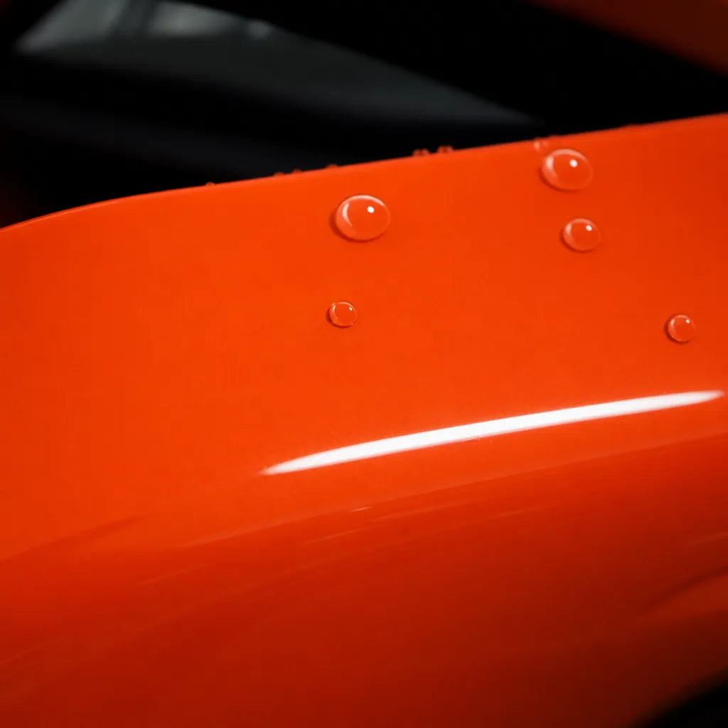 Close-up of Crystal Orange Red gloss colored PPF surface texture | Veloro