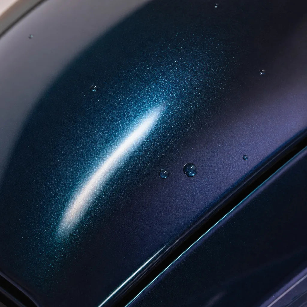 Close-up of Diamond Aurora Green gloss colored PPF surface texture | Veloro