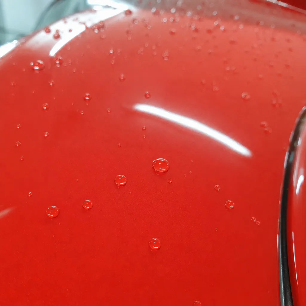 Close-up of Ferrari Red gloss colored PPF surface texture | Veloro