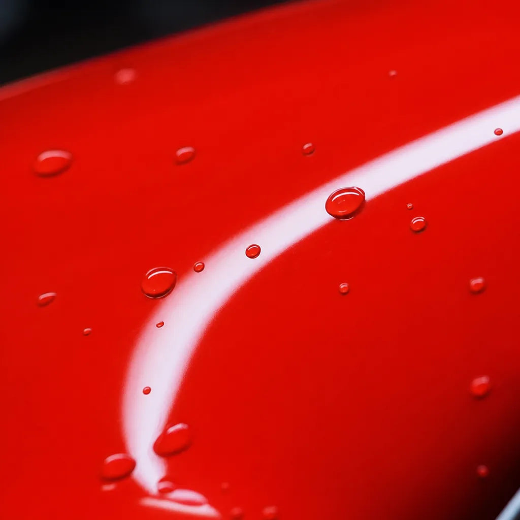 Close-up of Healing Ferrari Red gloss colored PPF surface texture | Veloro