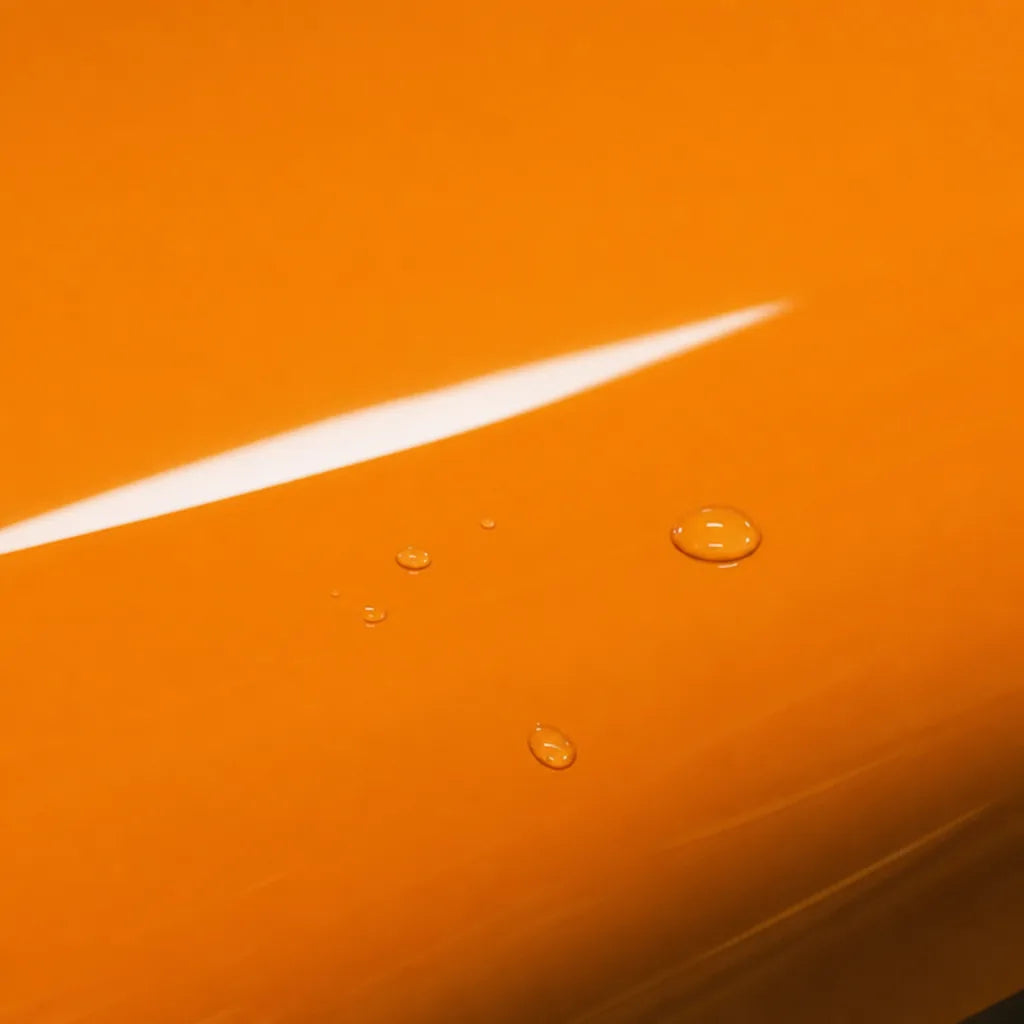 Close-up of Mclaren Orange gloss colored PPF surface texture | Veloro