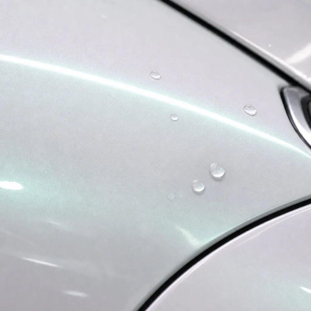 Close-up of Metallic Chameleon Dawning White gloss colored PPF surface texture | Veloro