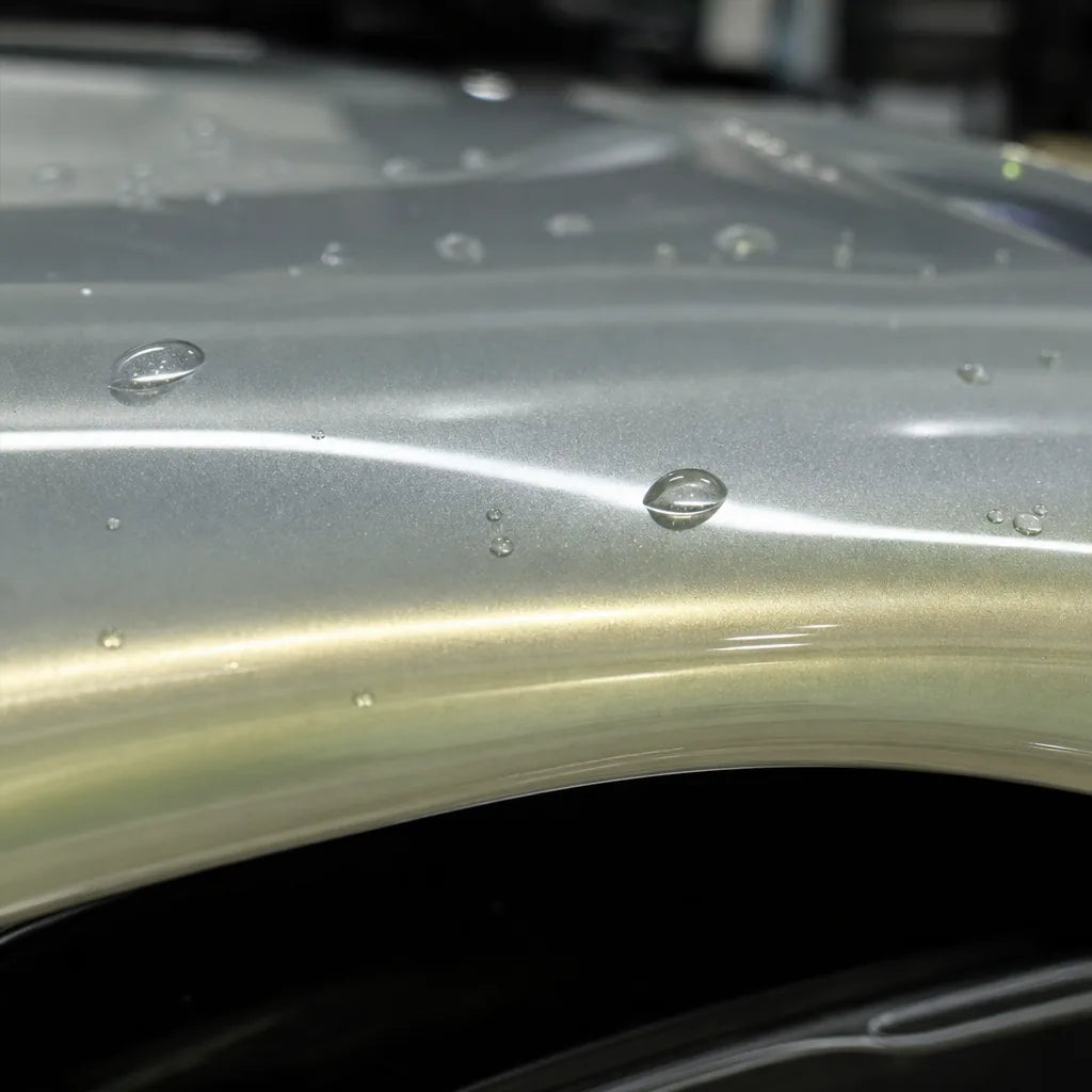 Close-up of Metallic Dawn Gold gloss colored PPF surface texture | Veloro