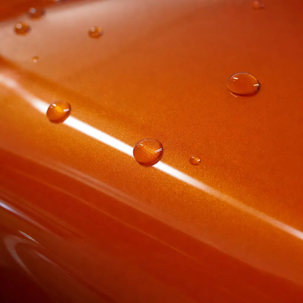 Close-up of Metallic Fiery Orange gloss colored PPF surface texture | Veloro