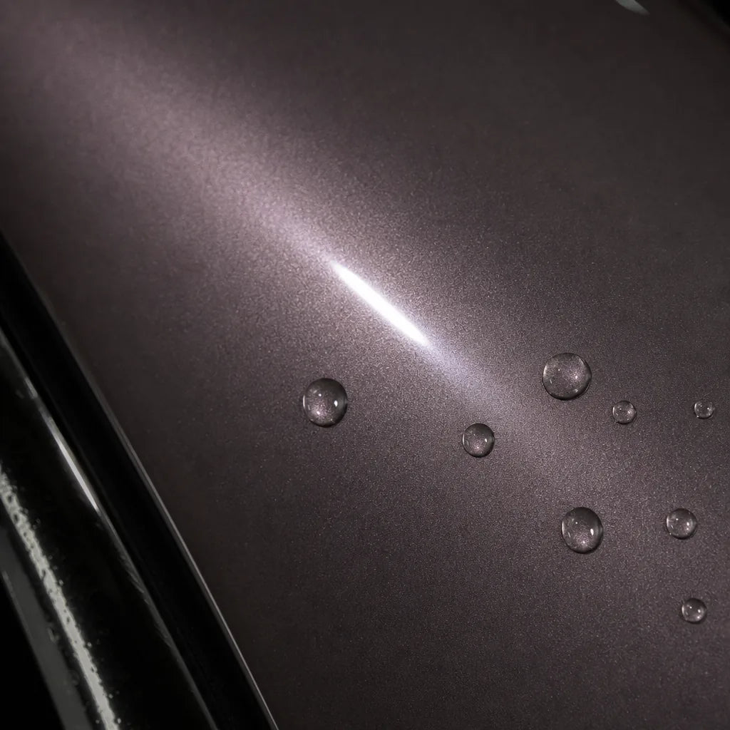 Close-up of Metallic Frozen Berry Pink gloss colored PPF surface texture | Veloro