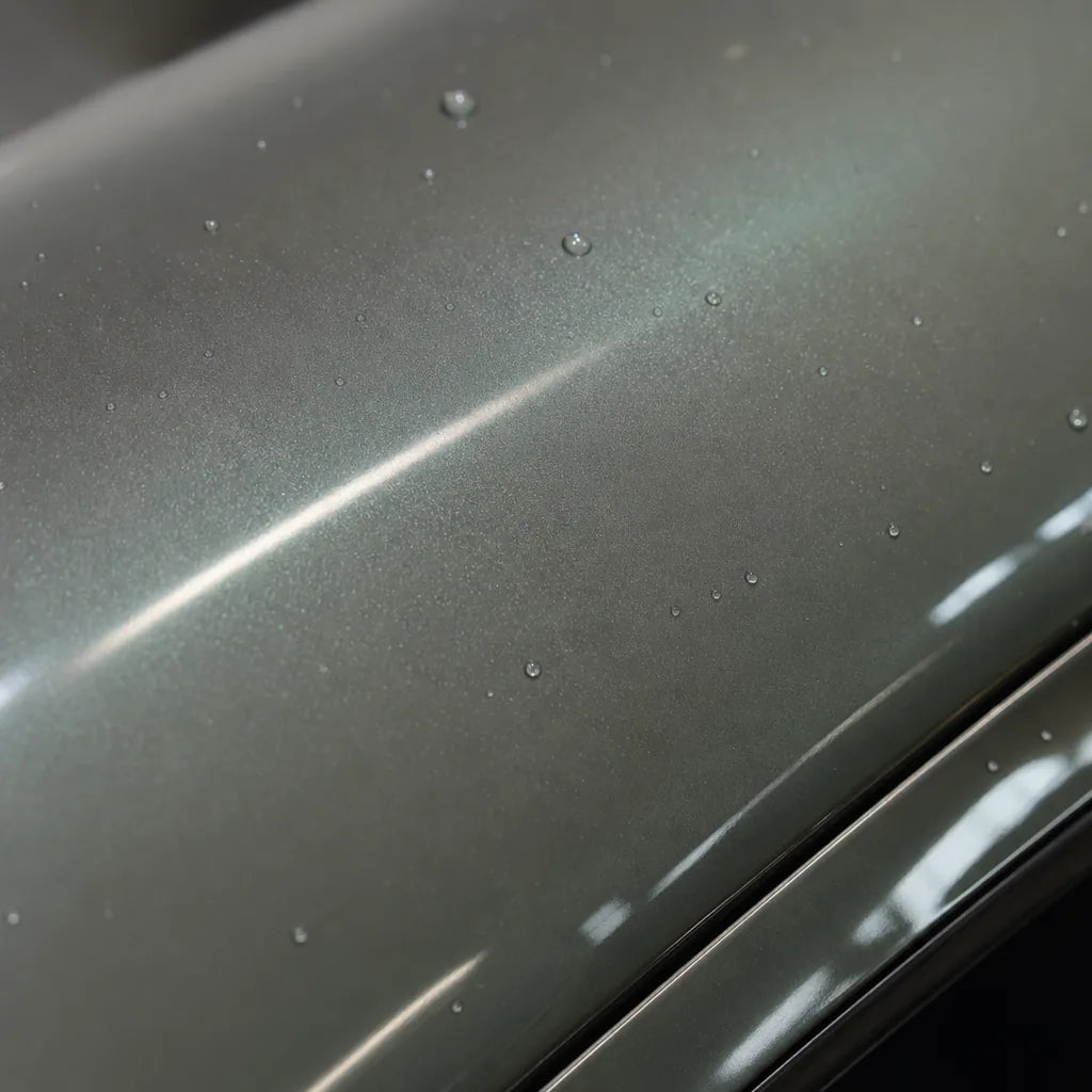 Close-up of Metallic Hadlin Green gloss colored PPF surface texture | Veloro