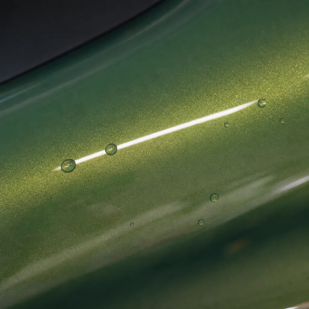 Close-up of Metallic Iridescent Emerald Green gloss colored PPF surface texture | Veloro