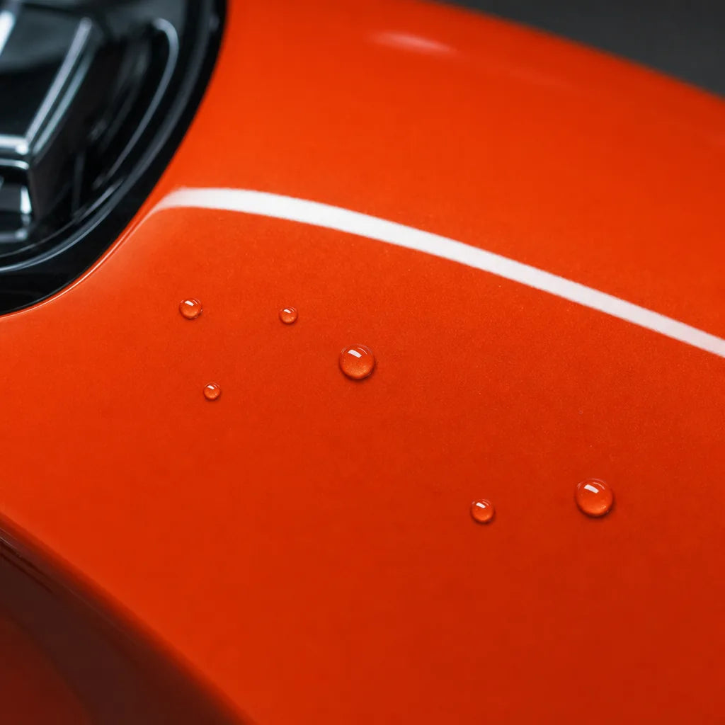 Close-up of Metallic Lava Orange gloss colored PPF surface texture | Veloro
