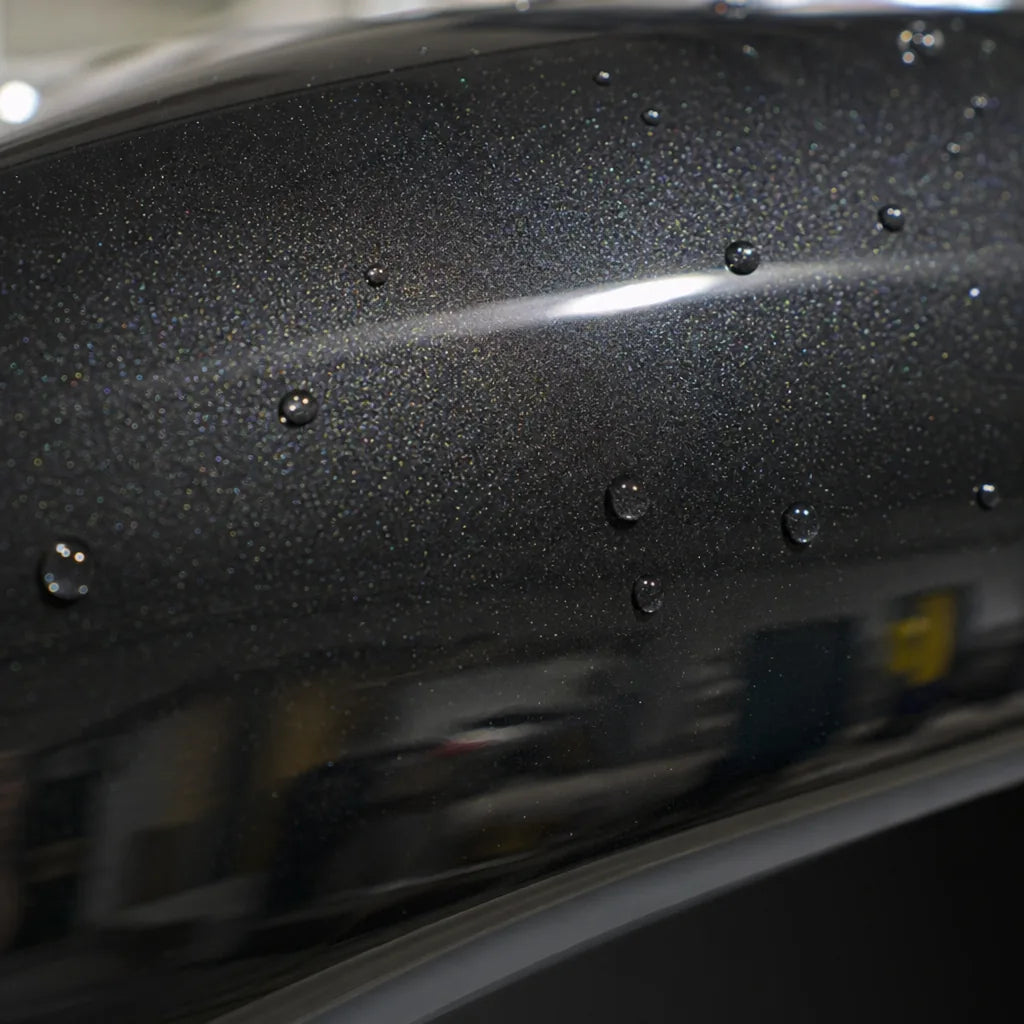 Close-up of Metallic Rainbow Laser Black Color PPF gloss colored PPF surface texture | Veloro
