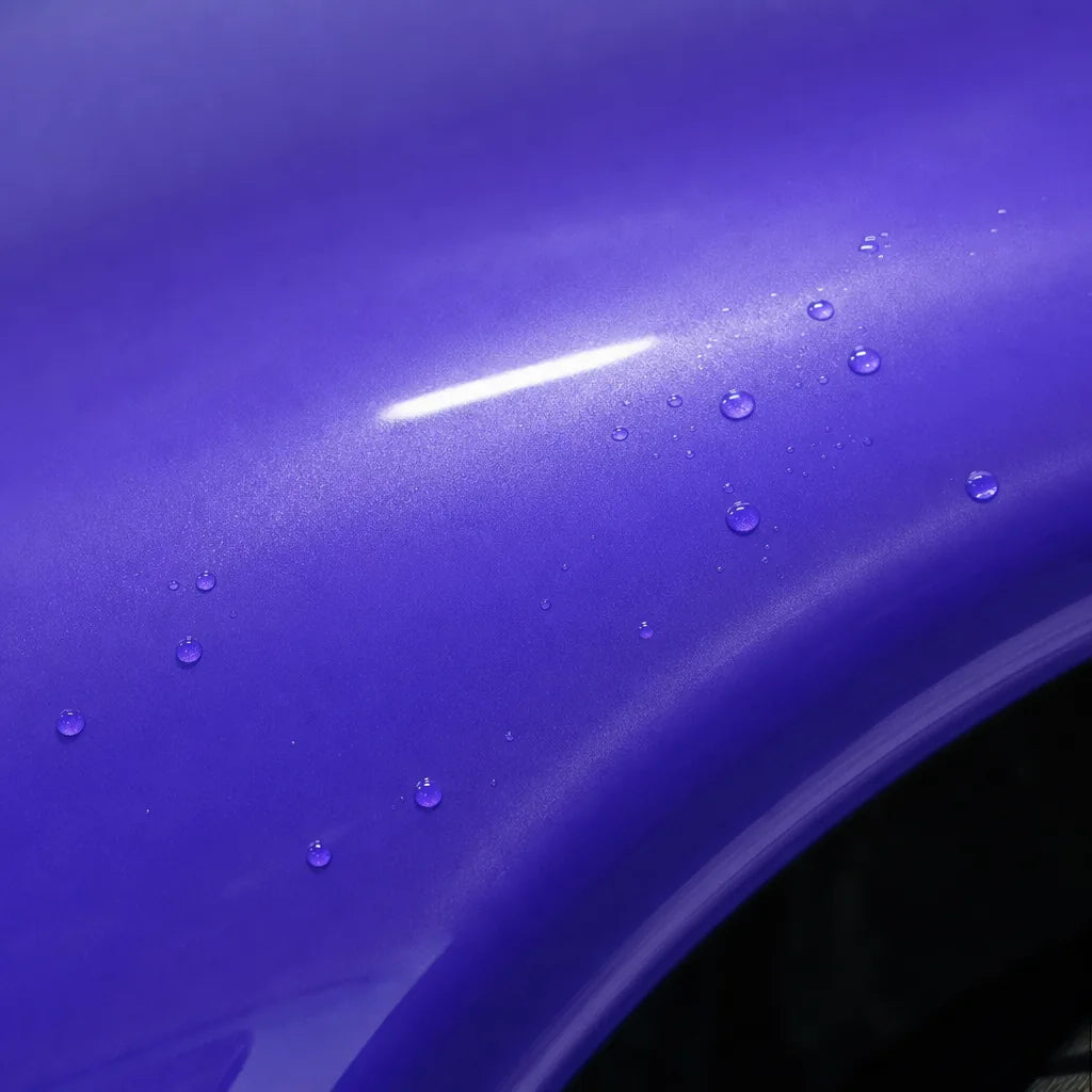 Close-up of Glossy Metallic Royalty Explosion Purple gloss colored PPF surface texture | Veloro
