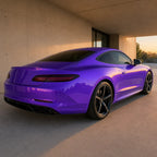 Luxury car wrapped in Glossy Metallic Royalty Explosion Purple gloss colored PPF at golden hour | Veloro