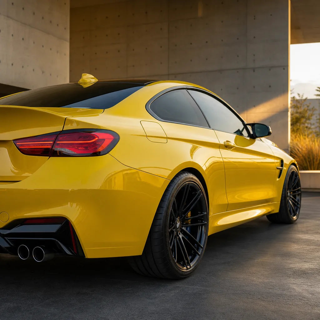 Luxury car wrapped in Glossy Signal Yellow gloss colored PPF at golden hour | Veloro