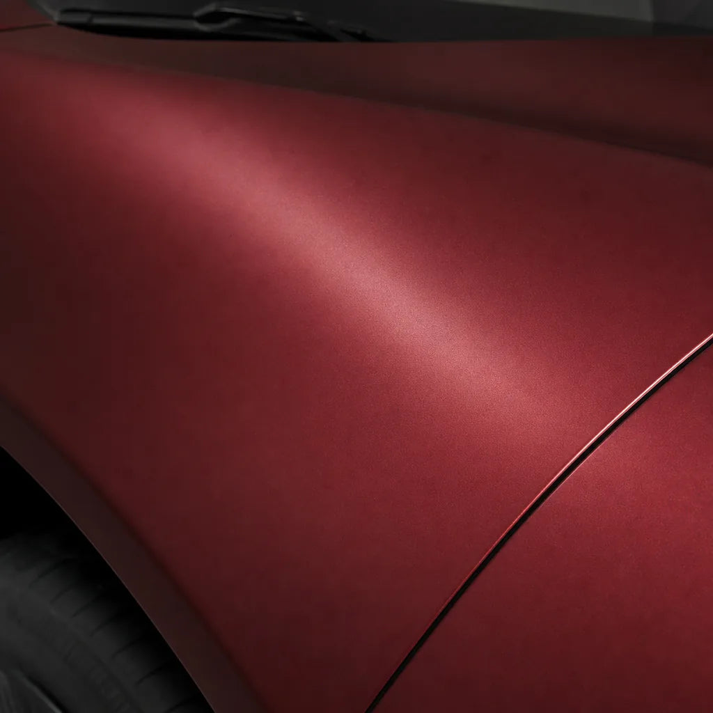 Close-up of Chrome Romani Red satin colored PPF surface texture | Veloro